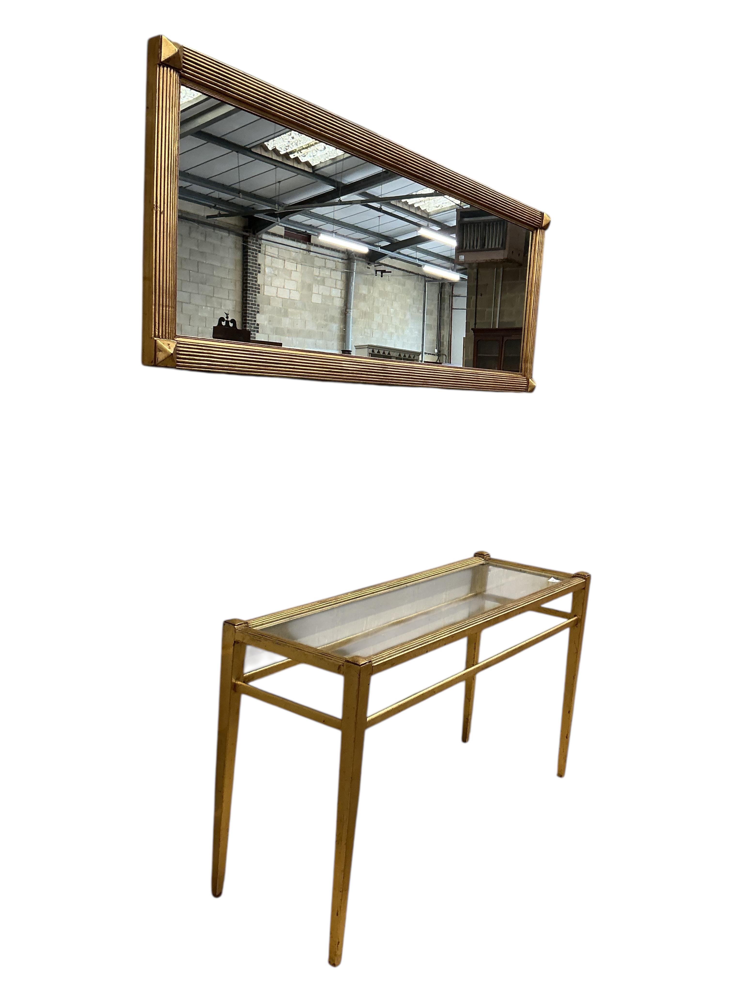 A reproduction gilt composition glass top console table, width 138cm, depth 46cm, height 78cm and a mirror